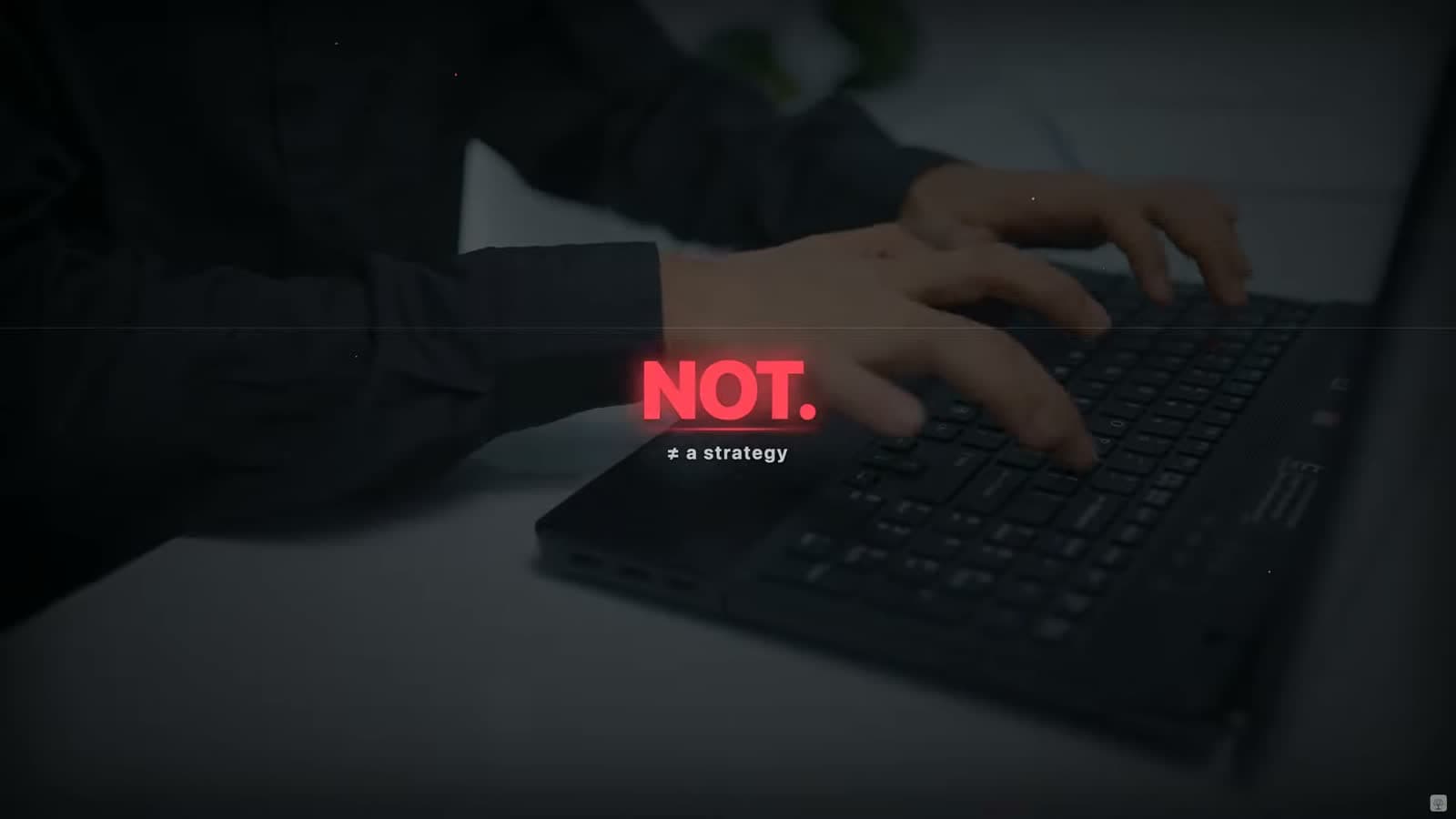 A person typing on a laptop with the text overlay 'NOT ≠ a strategy'